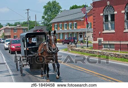 Amish woman in old fashioned covered horse carriage on street in Intercourse Pennsylvania in Lancaster area of Amish country View Large Photo Image Stock Photo - Amish woman in old fashioned covered horse carriage on street in Intercourse Pennsylvania in Lancaster area of Amish country. Fotosearch
