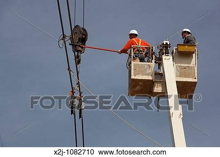 Amissville, Virginia - Worker build a high voltage power line The construction workers are members of the International Union of Operating Engineers View Large Photo Image Stock Image - Amissville, Virginia - Worker build a high voltage power line The construction workers are members of the International Union of Operating Engineers. Fotosearch