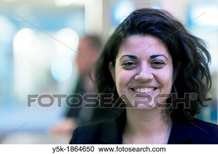 Stock Image - Amsterdam Airport, Amsterdam, Netherlands Young Italian woman during a conversation. Fotosearch