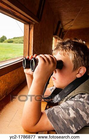 An 8 year old boy birdwatching in a hide at the Minsmere RSPB bird reserve in Suffolk, England, Britain, Uk View Large Photo Image Stock Photo - An 8 year old boy birdwatching in a hide at the Minsmere RSPB bird reserve in Suffolk, England, Britain, Uk. Fotosearch
