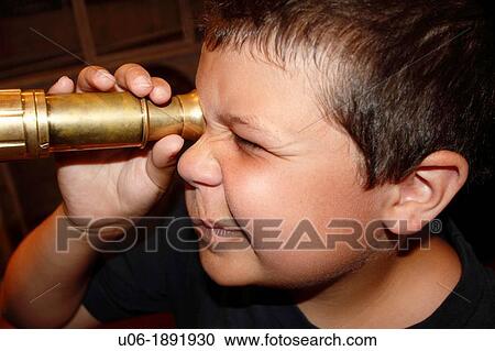 An 8 year old boy looking through an old brass antique telescope in a museum View Large Photo Image Stock Image - An 8 year old boy looking through an old brass antique telescope in a museum. Fotosearch