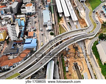 An aerial view of paraelle highways passing over the construction site of another roadway in Johor Bahru, Malaysia View Large Photo Image Stock Photography - An aerial view of paraelle highways passing over the construction site of another roadway in Johor Bahru, Malaysia. Fotosearch