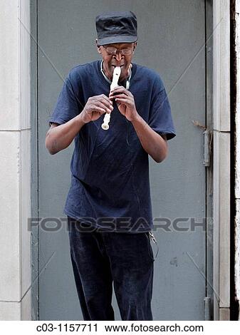 An African American street musician plays his recorder in a doorway on New York City's Madison Avenue View Large Photo Image Stock Image - An African American street musician plays his recorder in a doorway on New York City's Madison Avenue. Fotosearch