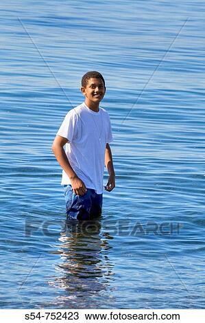 An African-American teen, 10-15, standing in water View Large Photo Image Stock Image - An African-American teen, 10-15, standing in water. Fotosearch