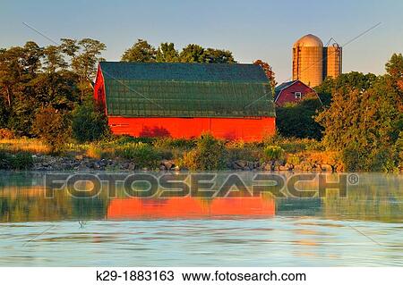 An aging red barn reflected into Gibson Lake waterway hydro controlled at dawn, Thorold, Ontario, Canada View Large Photo Image Stock Image - An aging red barn reflected into Gibson Lake waterway hydro controlled at dawn, Thorold, Ontario, Canada. Fotosearch