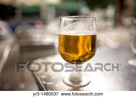 Stock Photo - An alcohol-free beer glass sit in a table of a restaurant in Cordoba, Andalusia, Spain, april 18, 2011. Fotosearch
