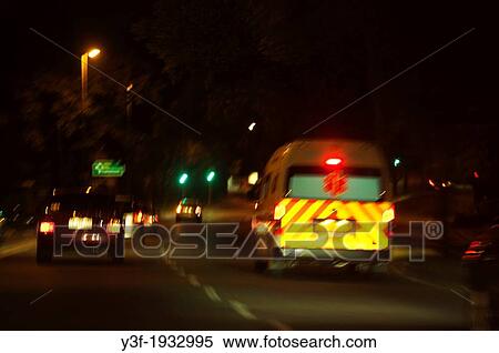 Stock Photography - An ambulance makes it's way through traffic at night. Fotosearch