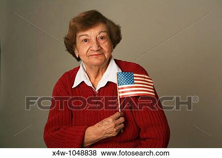 An American senior woman patriot holding flag View Large Photo Image Stock Photo - An American senior woman patriot holding flag. Fotosearch