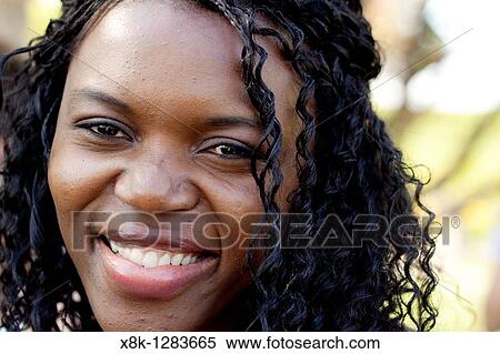 An Angolan woman looks at the camera and smiles View Large Photo Image Stock Photography - An Angolan woman looks at the camera and smiles. Fotosearch