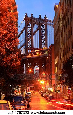 Stock Image - an area of brooklyn called dumbo, it is a suspension bridge that supports a train/subway line. Fotosearch
