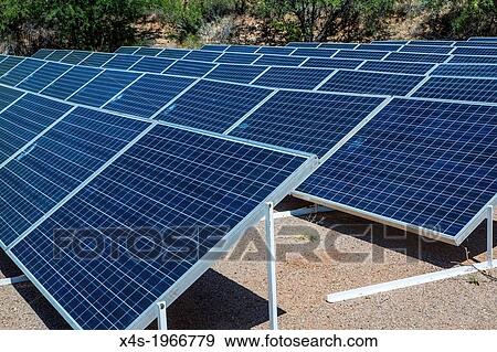 Stock Photo - An array of solar panels producing electricity at the Biosphere 2 research facility in Oracle, Arizona USA.. Fotosearch