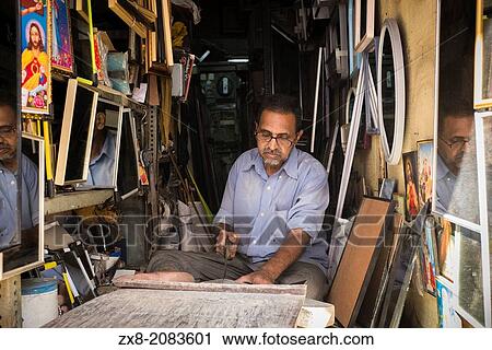 An artisan makes frames and mirrors in his small shop. View Large Photo Image Stock Image - An artisan makes frames and mirrors in his small shop.. Fotosearch