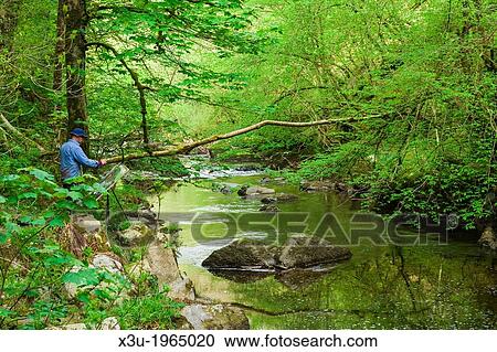 An artist painting on the riverbank of the East Lyn River in Exmoor National Park, Devon, England. View Large Photo Image Stock Image - An artist painting on the riverbank of the East Lyn River in Exmoor National Park, Devon, England.. Fotosearch