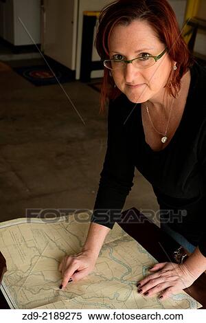 Stock Photography - An artist poses in her workshop.. Fotosearch