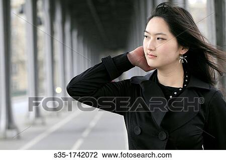 Stock Image - An asian girl in the pedestrians level of Pont Bir-Hakeim, Paris, France. Fotosearch