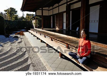 An asian woman meditates in the courtyard of the Garden of Solitary Sitting at the Zuiho-in, a sub-temple of the Daitokuji Monastery in Kyoto Japan View Large Photo Image Picture - An asian woman meditates in the courtyard of the Garden of Solitary Sitting at the Zuiho-in, a sub-temple of the Daitokuji Monastery in Kyoto Japan. Fotosearch
