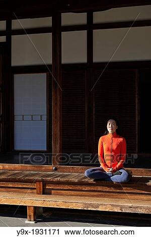 An asian woman meditates in the courtyard of the Garden of Solitary Sitting at the Zuiho-in, a sub-temple of the Daitokuji Monastery in Kyoto Japan View Large Photo Image Stock Image - An asian woman meditates in the courtyard of the Garden of Solitary Sitting at the Zuiho-in, a sub-temple of the Daitokuji Monastery in Kyoto Japan. Fotosearch
