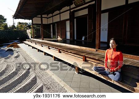 An asian woman meditates in the courtyard of the Garden of Solitary Sitting at the Zuiho-in, a sub-temple of the Daitokuji Monastery in Kyoto Japan View Large Photo Image Stock Photograph - An asian woman meditates in the courtyard of the Garden of Solitary Sitting at the Zuiho-in, a sub-temple of the Daitokuji Monastery in Kyoto Japan. Fotosearch