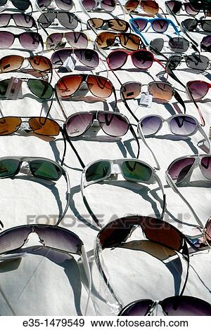 An assortment of sunglasses for sale at an outdoor market View Large Photo Image Stock Photo - An assortment of sunglasses for sale at an outdoor market. Fotosearch