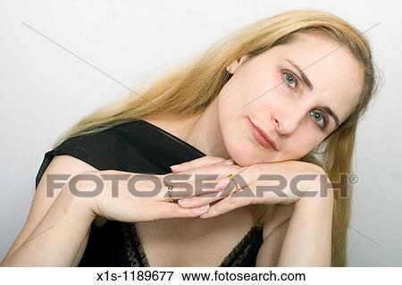 An attractive American woman with beautiful long, flowing blond hair with quiet expression looking at camera View Large Photo Image Stock Photo - An attractive American woman with beautiful long, flowing blond hair with quiet expression looking at camera. Fotosearch