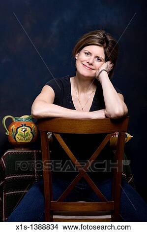 An attractive woman in jeans and a blue shirt View Large Photo Image Picture - An attractive woman in jeans and a blue shirt. Fotosearch
