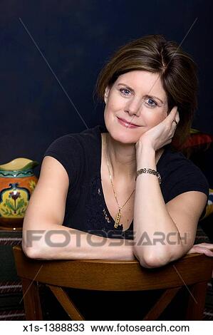 Stock Image - An attractive woman in jeans and a blue shirt. Fotosearch