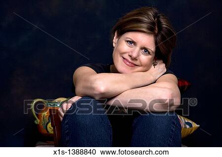 An attractive woman in jeans and a blue shirt View Large Photo Image Stock Image - An attractive woman in jeans and a blue shirt. Fotosearch