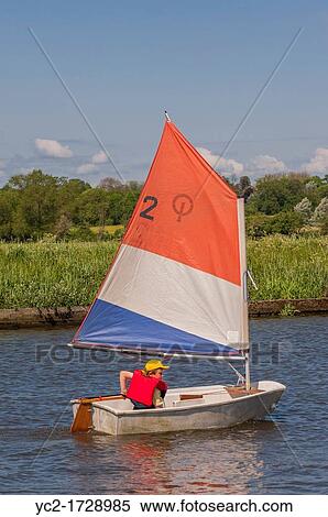 An eight year old boy sailing in an optimist dinghy boat in the Uk View Large Photo Image Stock Photography - An eight year old boy sailing in an optimist dinghy boat in the Uk. Fotosearch