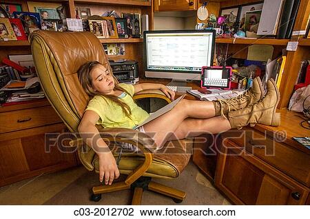 An eight-year-old girl seems exhausted with miltitasking using a computer, a tablet, a cell phone, and a writing pad at home in Laguna Beach, CA. View Large Photo Image Stock Image - An eight-year-old girl seems exhausted with miltitasking using a computer, a tablet, a cell phone, and a writing pad at home in Laguna Beach, CA.. Fotosearch