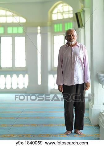 An elder man praying in a mosque View Large Photo Image Stock Photo - An elder man praying in a mosque. Fotosearch