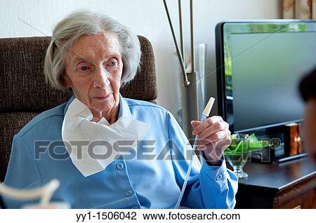 An elderly inhabitant of a Rotterdam nursing home is having her stomach-pump taken care of by a nurse. View Large Photo Image Stock Image - An elderly inhabitant of a Rotterdam nursing home is having her stomach-pump taken care of by a nurse.. Fotosearch