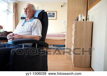 An elderly inhabitant of a Rotterdam nursing home, sitting in the chair of his private living room. View Large Photo Image Stock Photo - An elderly inhabitant of a Rotterdam nursing home, sitting in the chair of his private living room.. Fotosearch