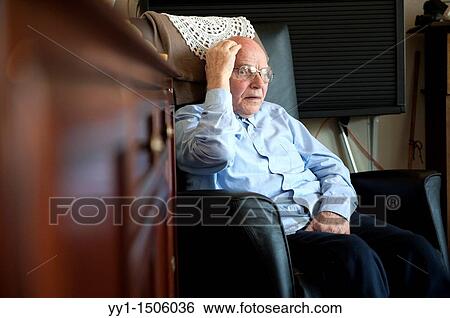 An elderly inhabitant of a Rotterdam nursing home, sitting in his regular chair in the communal living room. View Large Photo Image Stock Photograph - An elderly inhabitant of a Rotterdam nursing home, sitting in his regular chair in the communal living room.. Fotosearch