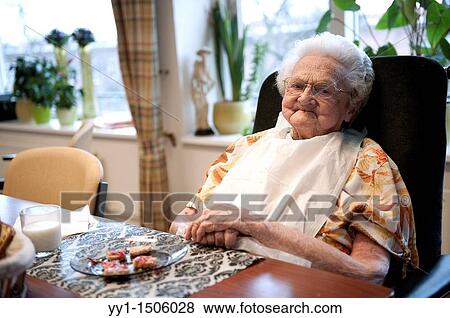 An elderly resident of a nursing home having breakfast at the communal breakfast table. View Large Photo Image Stock Photo - An elderly resident of a nursing home having breakfast at the communal breakfast table.. Fotosearch