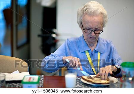 An elderly resident of a nursing home having breakfast at the communal breakfast table. View Large Photo Image Stock Photography - An elderly resident of a nursing home having breakfast at the communal breakfast table.. Fotosearch
