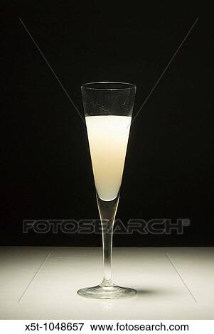 An elegant glass of grapefruit juice on a black background View Large Photo Image Stock Photo - An elegant glass of grapefruit juice on a black background. Fotosearch