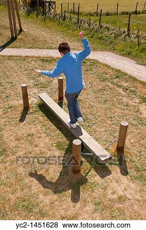 An eleven year old boy balancing at the play park in Westleton, Suffolk, England, Britain, Uk View Large Photo Image Stock Photo - An eleven year old boy balancing at the play park in Westleton, Suffolk, England, Britain, Uk. Fotosearch