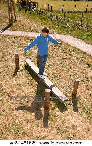 An eleven year old boy balancing at the play park in Westleton, Suffolk, England, Britain, Uk View Large Photo Image Stock Photo - An eleven year old boy balancing at the play park in Westleton, Suffolk, England, Britain, Uk. Fotosearch