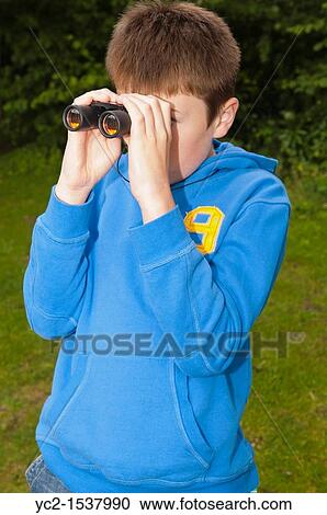 An eleven year old boy birdwatching with binoculars at Fairhaven woodland and water garden in South Walsham, Norfolk, England, Britain, Uk View Large Photo Image Stock Image - An eleven year old boy birdwatching with binoculars at Fairhaven woodland and water garden in South Walsham, Norfolk, England, Britain, Uk. Fotosearch