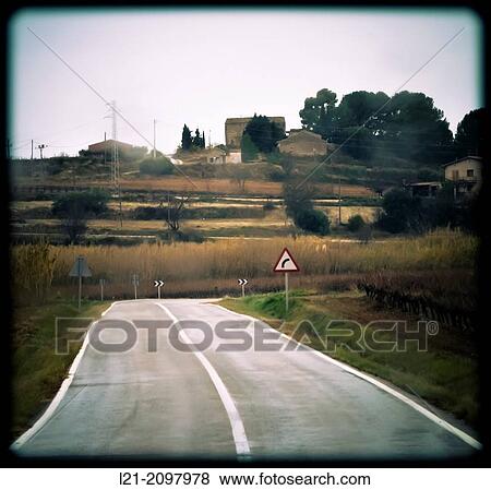 An empty road with a white line down the middle and traffic sign. Barcelona province, Catalonia, Spain. View Large Photo Image Stock Photo - An empty road with a white line down the middle and traffic sign. Barcelona province, Catalonia, Spain.. Fotosearch