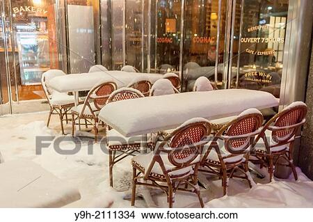 An empty snow covered outdoor cafe in New York during a snow storm View Large Photo Image Picture - An empty snow covered outdoor cafe in New York during a snow storm. Fotosearch