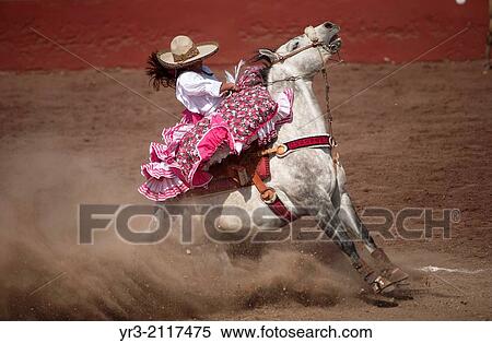 Stock Photography - An escaramuza sits on her horse before competing in an Escaramuza in the Lienzo Charros el Penon, Mexico City, Sunday, January 19, 2013.. Fotosearch