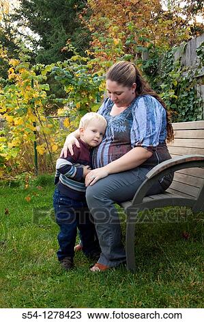 An expectant mother and her two-year-old son outdoors View Large Photo Image Stock Image - An expectant mother and her two-year-old son outdoors. Fotosearch