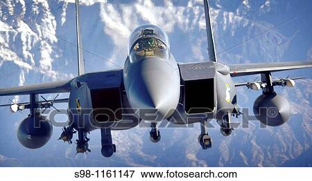 Stock Photo - An F-15E Strike Eagle soars over the mountains of Afghanistan in support of Operation Mountain Lion April 12, 2006. Fotosearch