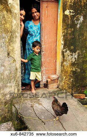 An Indian Family looking out of their home doorway Fort Cochin, Kerala, India View Large Photo Image Stock Photography - An Indian Family looking out of their home doorway Fort Cochin, Kerala, India. Fotosearch