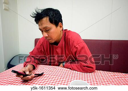 An Indonesian seaman or sailor on the container-vessel MV Flintercape, during a journey from Rotterdam, Netherlands, to Sundsvall, Sweden. View Large Photo Image Picture - An Indonesian seaman or sailor on the container-vessel MV Flintercape, during a journey from Rotterdam, Netherlands, to Sundsvall, Sweden.. Fotosearch