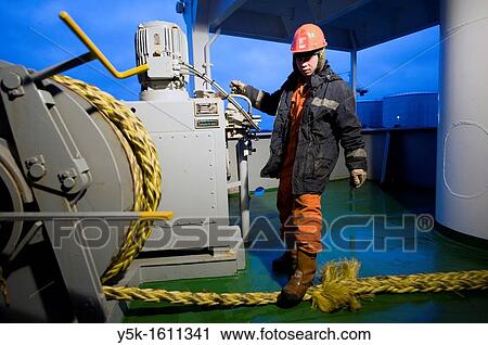 Stock Image - An Indonesian seaman or sailor on the container-vessel MV Flintercape, during a journey from Rotterdam, Netherlands, to Sundsvall, Sweden. The man is an? Able Seaman?, who generally works on deck, and is now busy with meering the ship to the dock.. Fotosearch