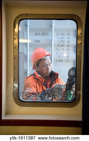 An Indonesian seaman or sailor on the container-vessel MV Flintercape, during a journey from Rotterdam, Netherlands, to Sundsvall, Sweden. View Large Photo Image Stock Photo - An Indonesian seaman or sailor on the container-vessel MV Flintercape, during a journey from Rotterdam, Netherlands, to Sundsvall, Sweden.. Fotosearch