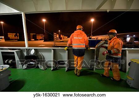 Stock Image - An Indonesian Seamen or sailor and a Dutch Cadet on the container-vessel MV Flintercape, during a journey from Rotterdam, Netherlands, to Sundsvall, Sweden.. Fotosearch