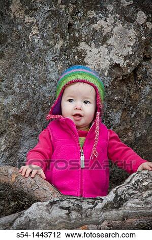 Stock Image - An infant girl outdoors. Fotosearch